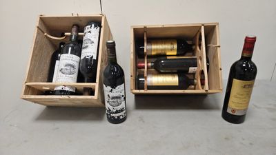 two bottles of wine are in a wooden box next to a bottle of wine