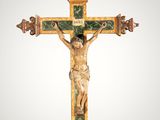 an old wooden crucif with a cross on it ' s side