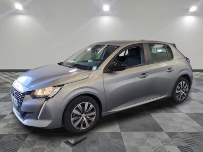 a silver car parked on a checkered floor in a garage