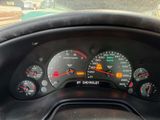 a close up of a car dashboard with a speedometer and gauges