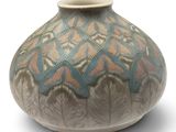 a vase that is sitting on a white surface