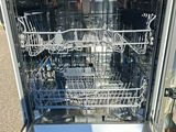 a dishwasher that is open in the kitchen