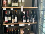 many bottles of wine on the shelves in the store