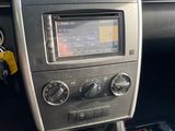 the dashboard of a car with a radio and a remote control