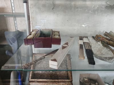 a glass display case with various items in it