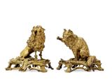 pair of bronze lion figurines on tree stumps