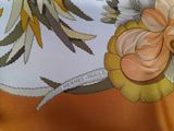 a picture of a close up of a scarf with a flower on it