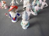 many figurines of different sizes and colors on the table