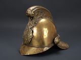 an antique brass fire helmet with a helmet on top of it