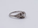 a close up of a diamond ring on a white surface