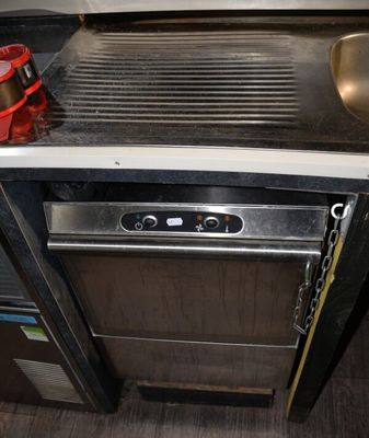a sink and a stove in a small kitchen