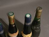 three bottles of wine sitting on a counter top