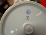 a close up view of a white vase with a blue and green design