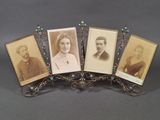four antique photo frames of a man, woman, and child