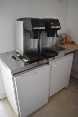 two coffee machines sitting on top of a counter