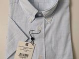 men ' s light blue dress shirt with a tag on the collar