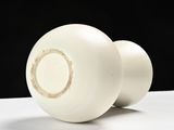 two white balls sitting on a white surface