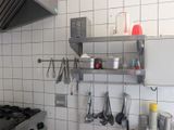a picture of a kitchen with pots and pans hanging on the wall