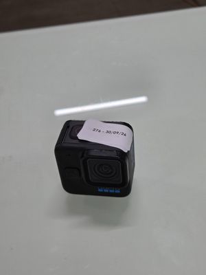 a small camera on a table with a sticker on it