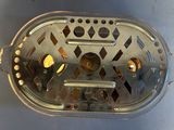 a small metal object with holes in it on a table