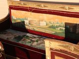 a bench with a painting on the back of it
