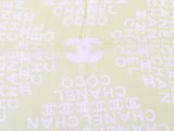 a chanel logo on a yellow shirt with white writing