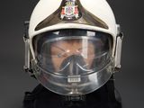 a man wearing a helmet and a gas mask on a black background