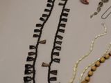 a lot of necklaces that are laying on a table