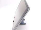 a tablet computer sitting on a stand on a white surface