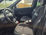 the interior of a car with the door open and the driver ' s seat down