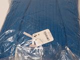 a blue blanket wrapped in plastic on a white table