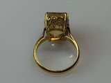 an image of a yellow gold ring with a square cut diamond