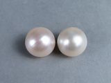 a pair of white pearls sitting on top of a gray surface