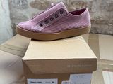 pair of pink slip on shoes sitting on top of a cardboard box