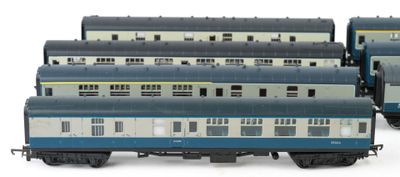 several blue and white train cars sitting next to each other on a white surface