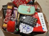 a cardboard box filled with assorted items on the floor
