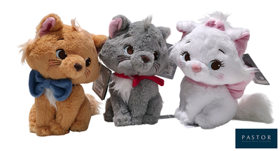 three stuffed animals sitting next to each other on a white background