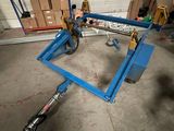 a blue scissor sitting in a garage with boxes