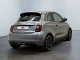the back of a silver car is parked in a room