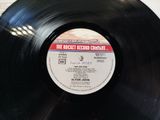 an old record with a label on it sitting on top of a table