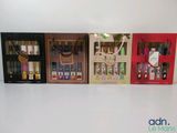 four bottles of perfume are lined up in a row