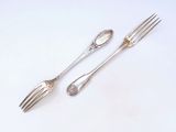 two forks and two spoons on a white surface