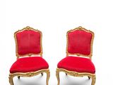 pair of red and gold chairs with red velvet upholstered seats