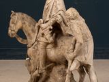 a statue of a woman riding a horse with a man on it