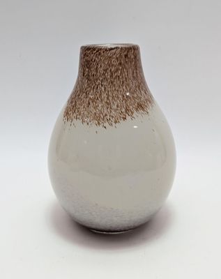 a white and brown vase sitting on a white surface