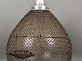 a silver vase with a fish head on it