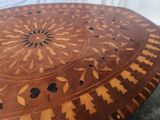 a wooden table with a decorative design on it