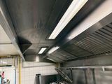a large kitchen with stainless steel appliances in it