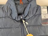 the jacket is blue and has a yellow tag on it