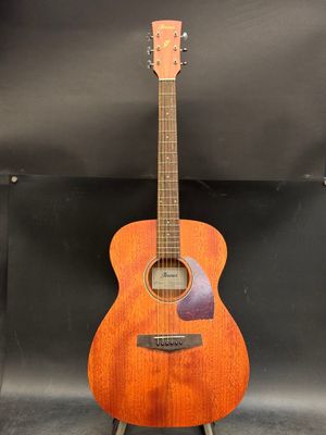 a wooden guitar sitting on top of a metal stand